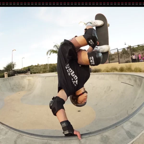 Skater wearing 187 Six Pack Pad Set doing an invert on a concrete bowl