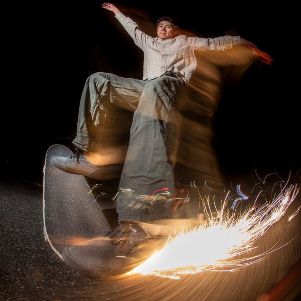 Lucas Wong skating with a Tail Devil at night, creating sparks while dragging his tail.