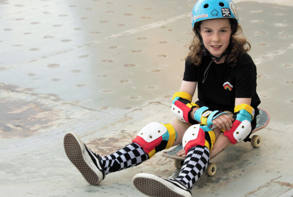 Girl on skateboard wearing Trinity Youth Pad Pack Retro