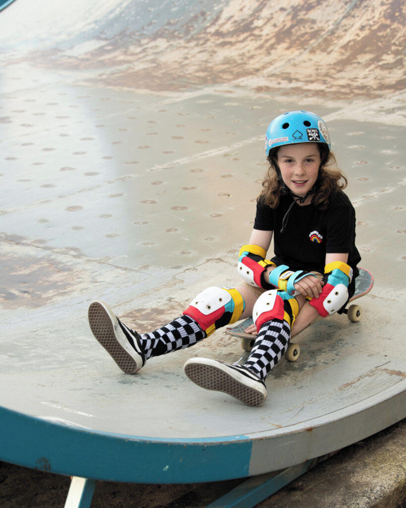 Girl on skateboard wearing Trinity Youth Pad Pack Retro