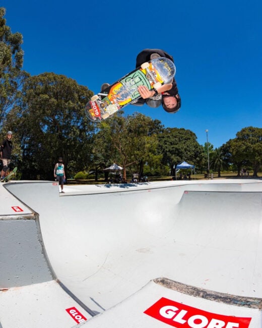 Dylan Donnini executing a frontside indy grab over the channel at Five Dock Skatepark